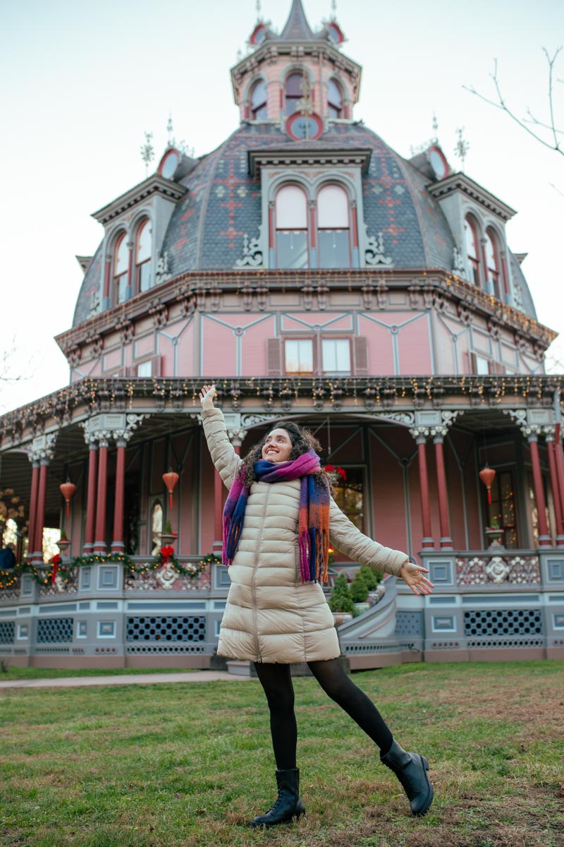 A woman standing in front of Armour-Stiner Octagon House