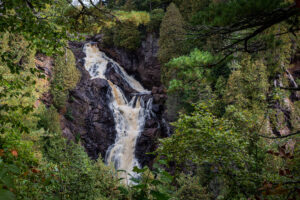 Big Manitou Falls in Wisconsin water cascading on rock surrounded by trees