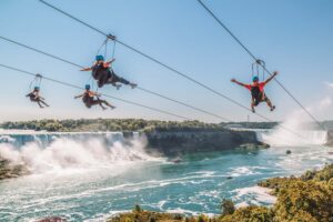 People riding ziplines over Niagara Falls