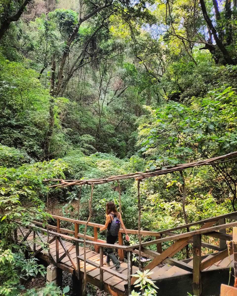 A woman hiking at Finca el Pilar in Antigua, Guatemala
