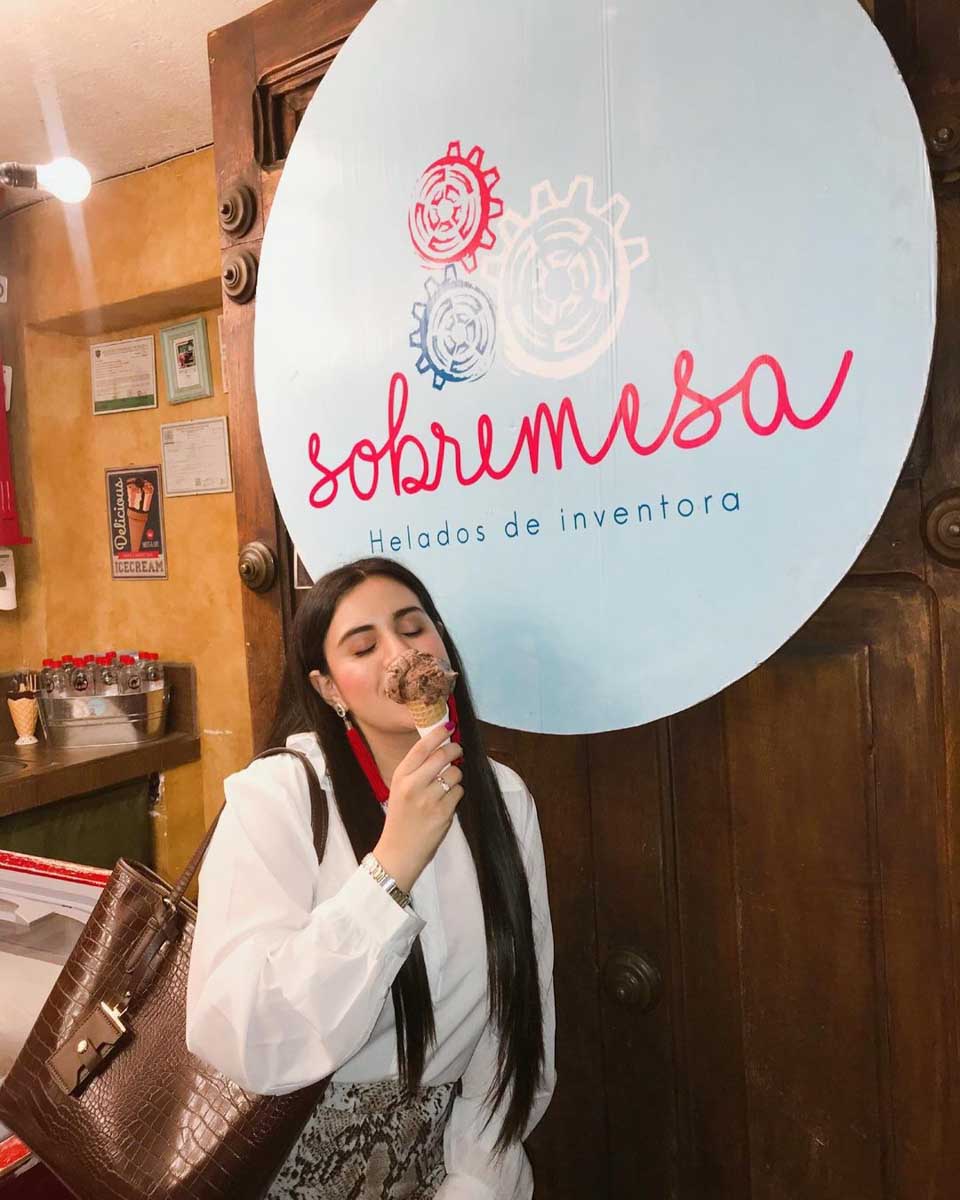A woman eating gelato at Sobremesa Helados Exoticos in Antigua, Guatemala