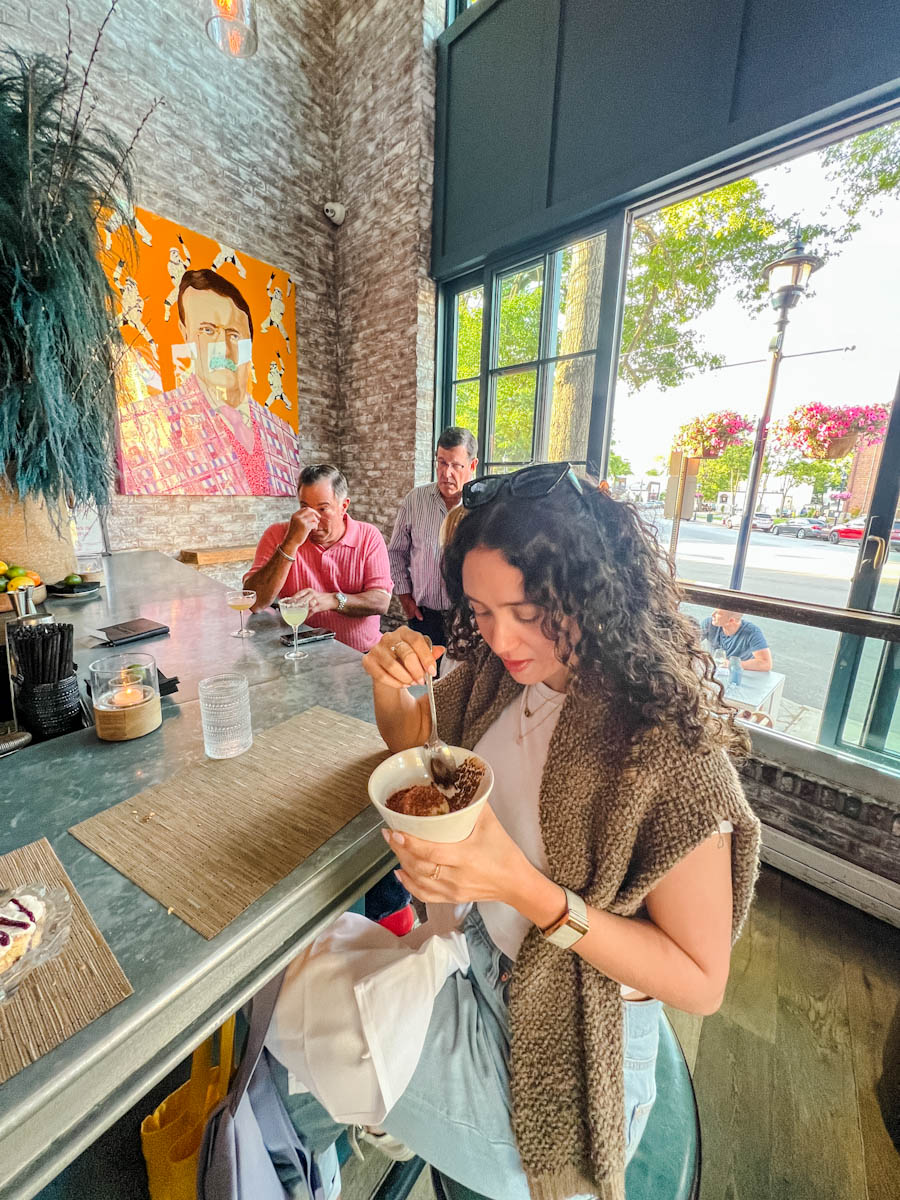 A woman eating in a restaurant in Oyster Bay