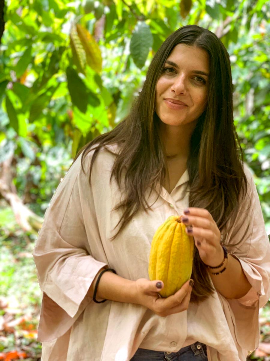 A woman holding a cacao fruit