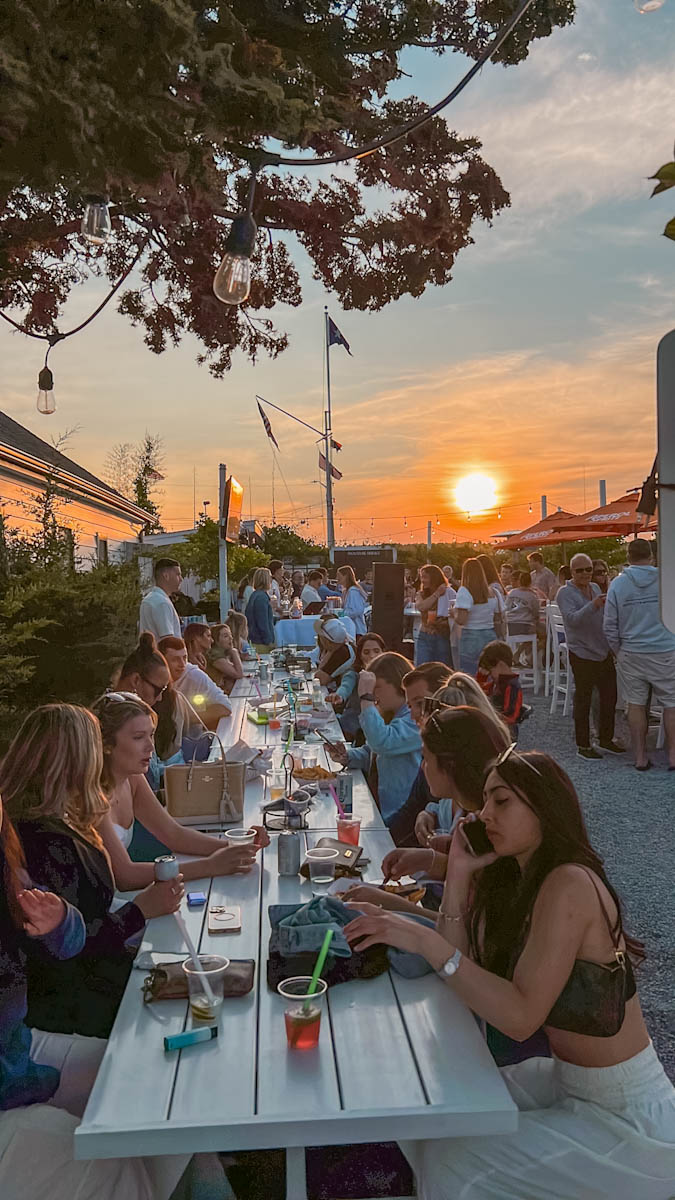 People interacting at Cooper Bluff Waterfront Bar in Oyster Bay, Long Island
