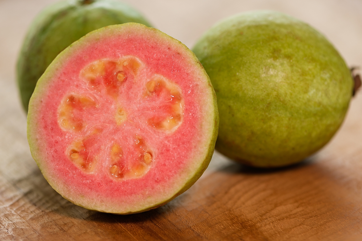 Three pieces of guayaba on a wooden surface