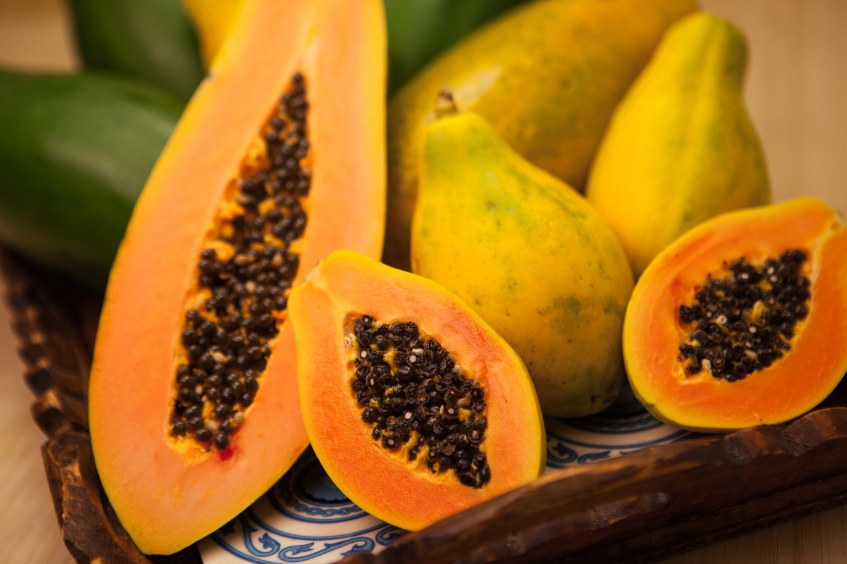 Whole and sliced papayas