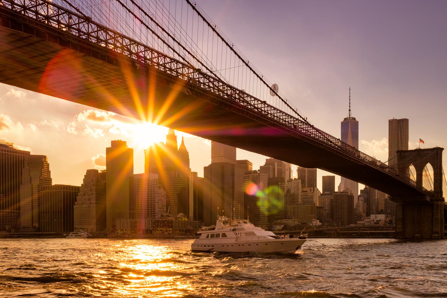 A boat on a river in New York City at sunset