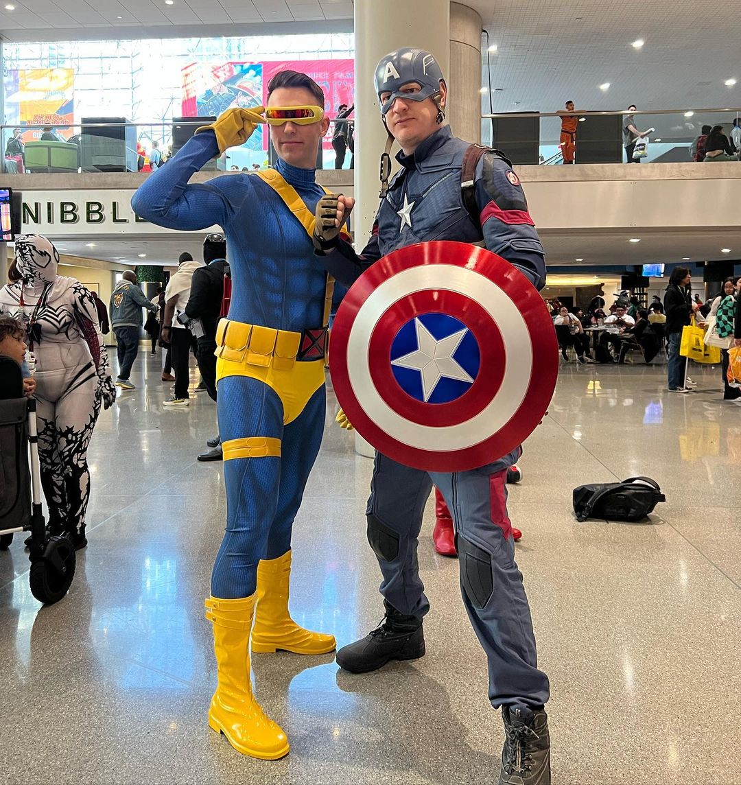 Two men in superhero costumes posing for a photograph at the New York Comic Con