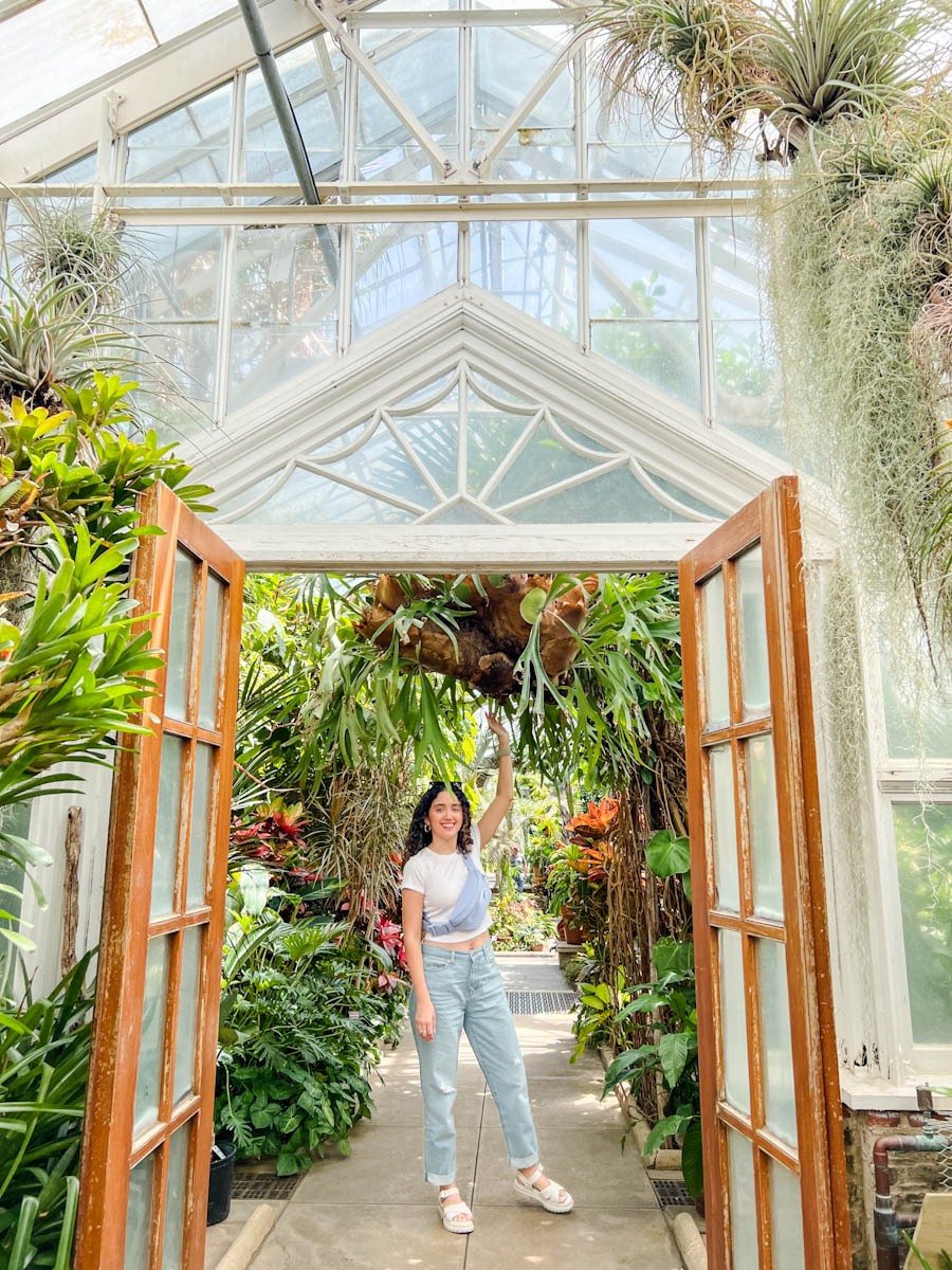 A woman in a greenhouse at Planting Fields Arboretum and State Park in Oyster Bay, Long Island