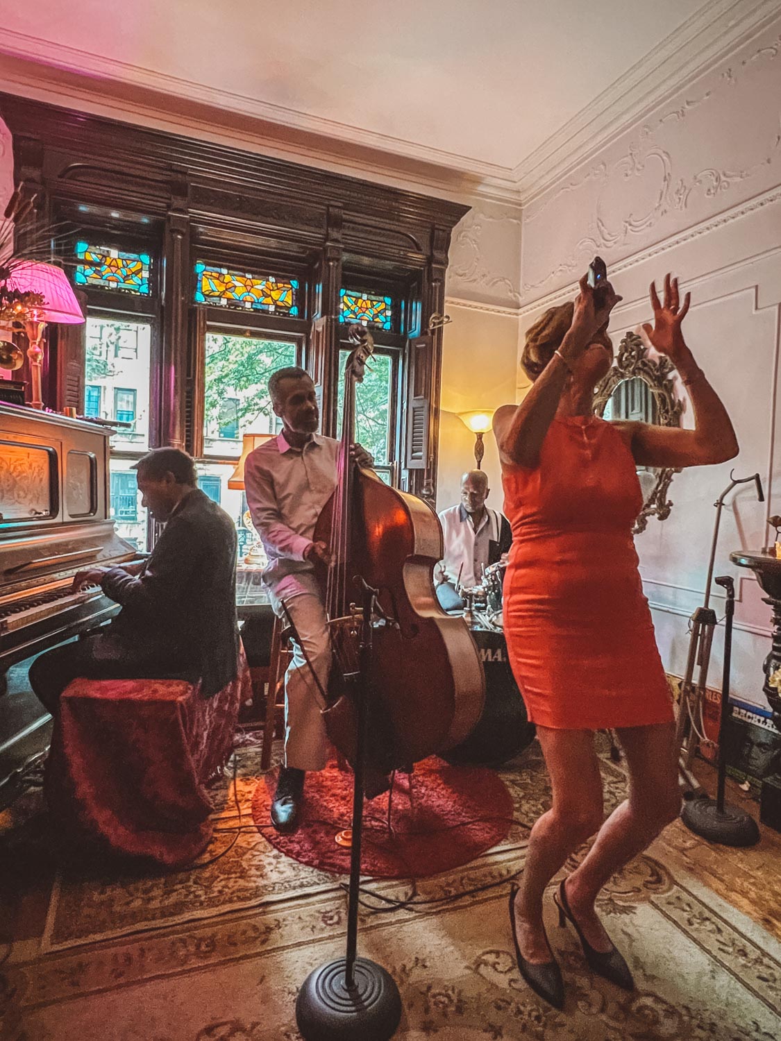 Four people, either singing or playing a musical instrument, performing in Brownstone Jazz, New York City