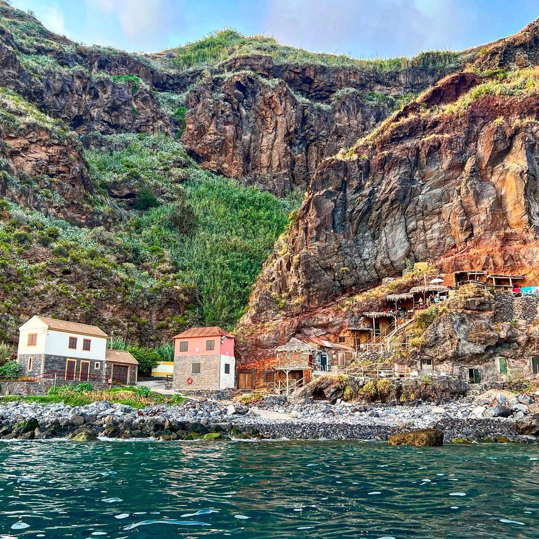The Calhau da Lapa Beach, sea, cliffs, and cave houses
