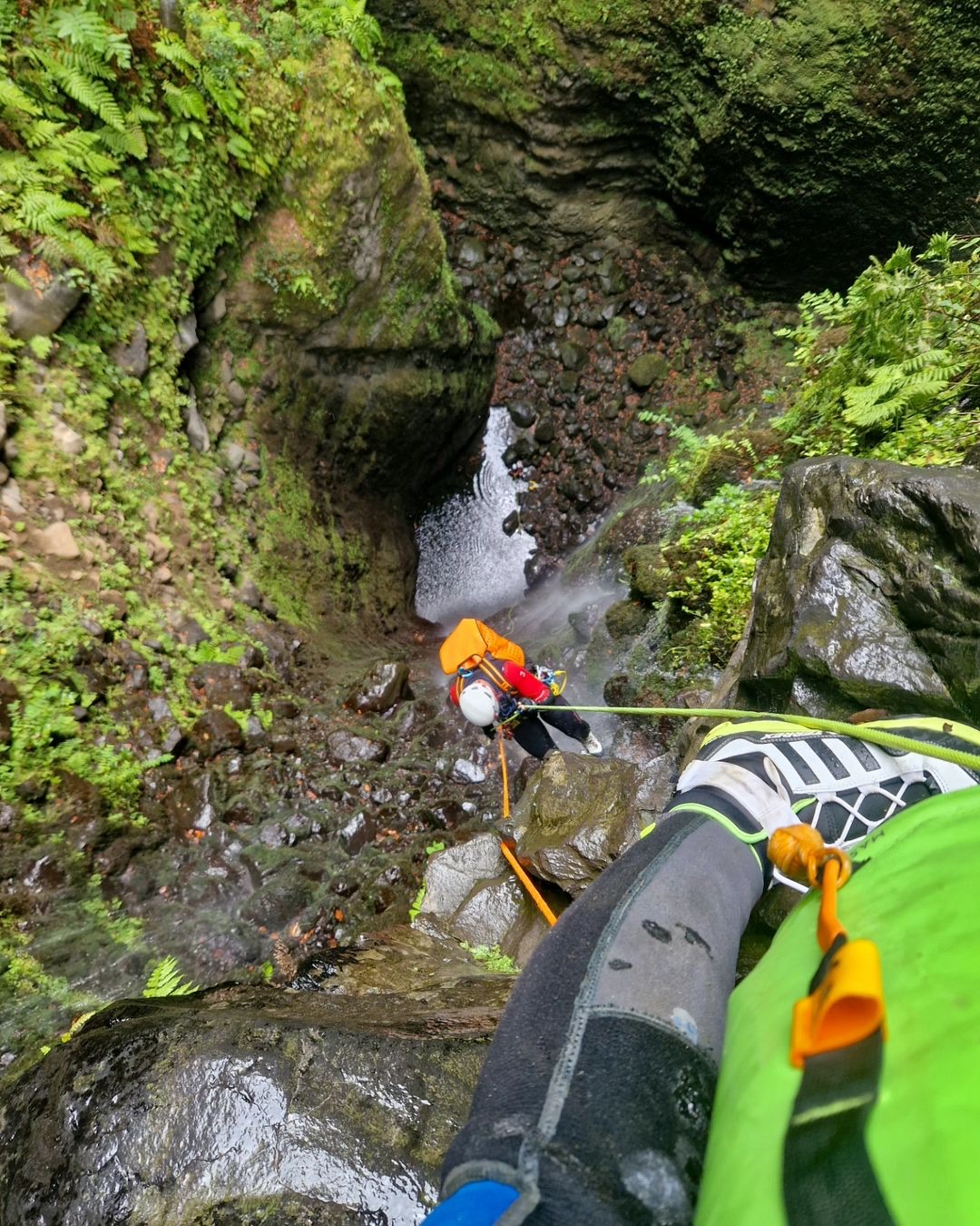 A person canyoneering down a waterfall in Madeira