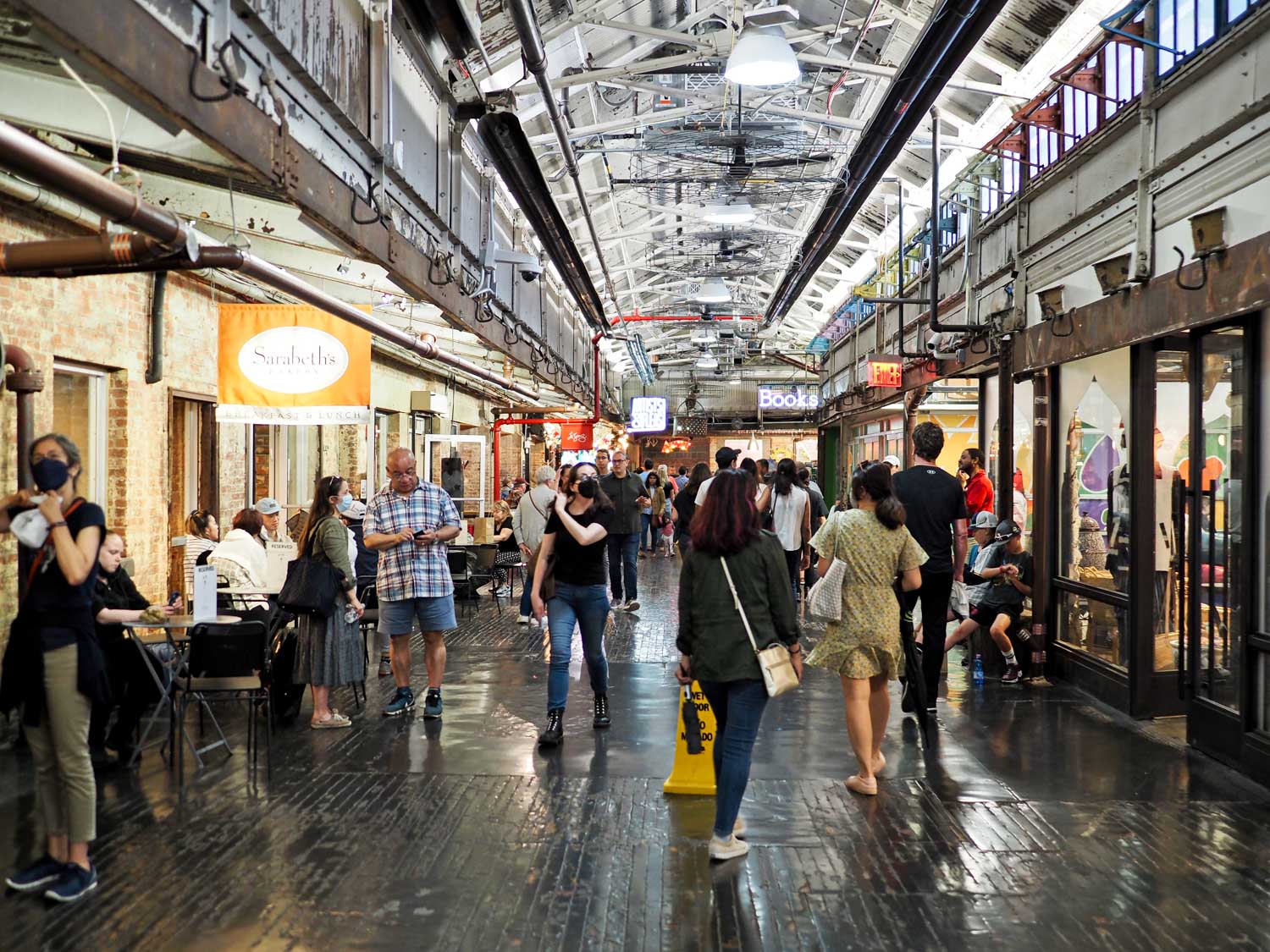 People walking inside the Chelsea Market in New York City
