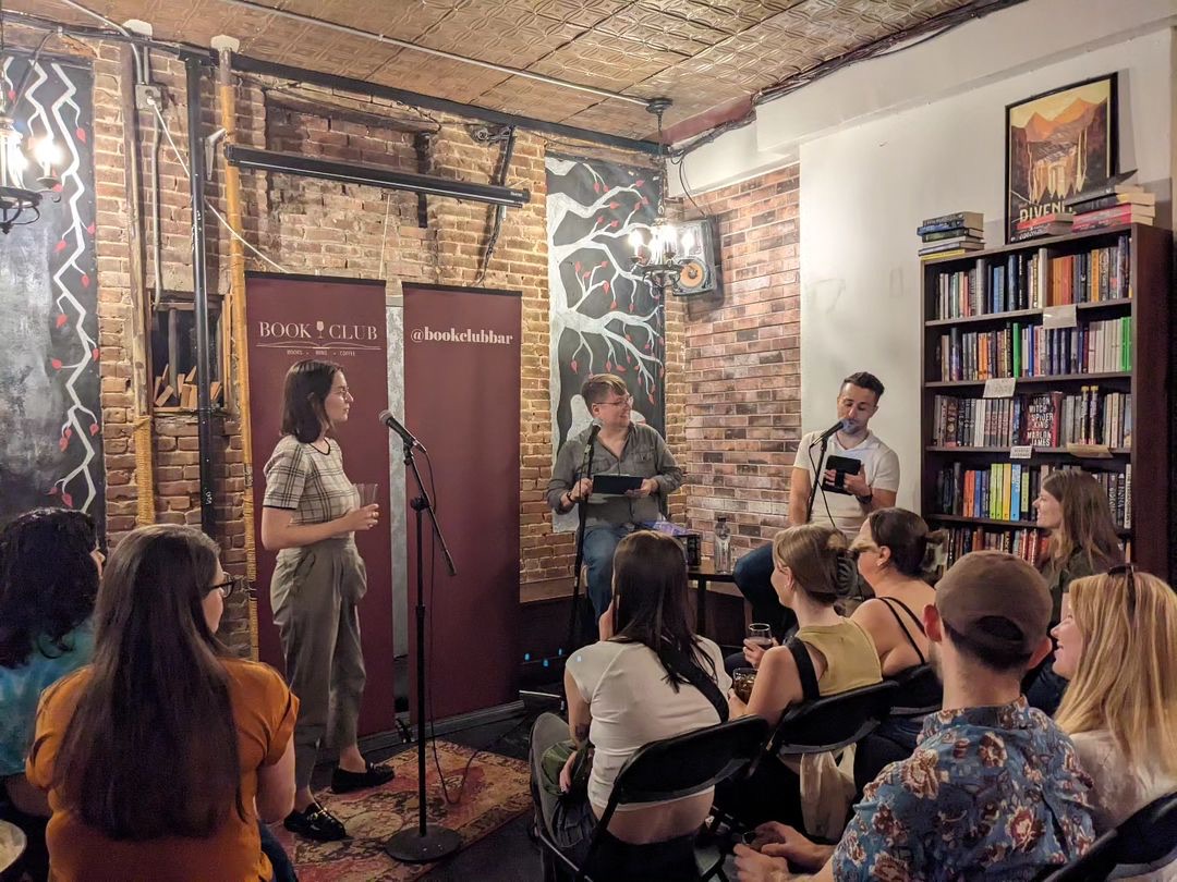 Three people at the front talking with a seated audience listening at a book store book club in New York City indoor activities