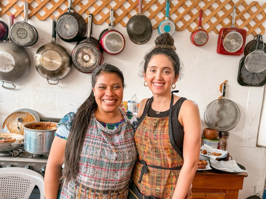 A female chef and a female student in a Mayan cooking class kitchen