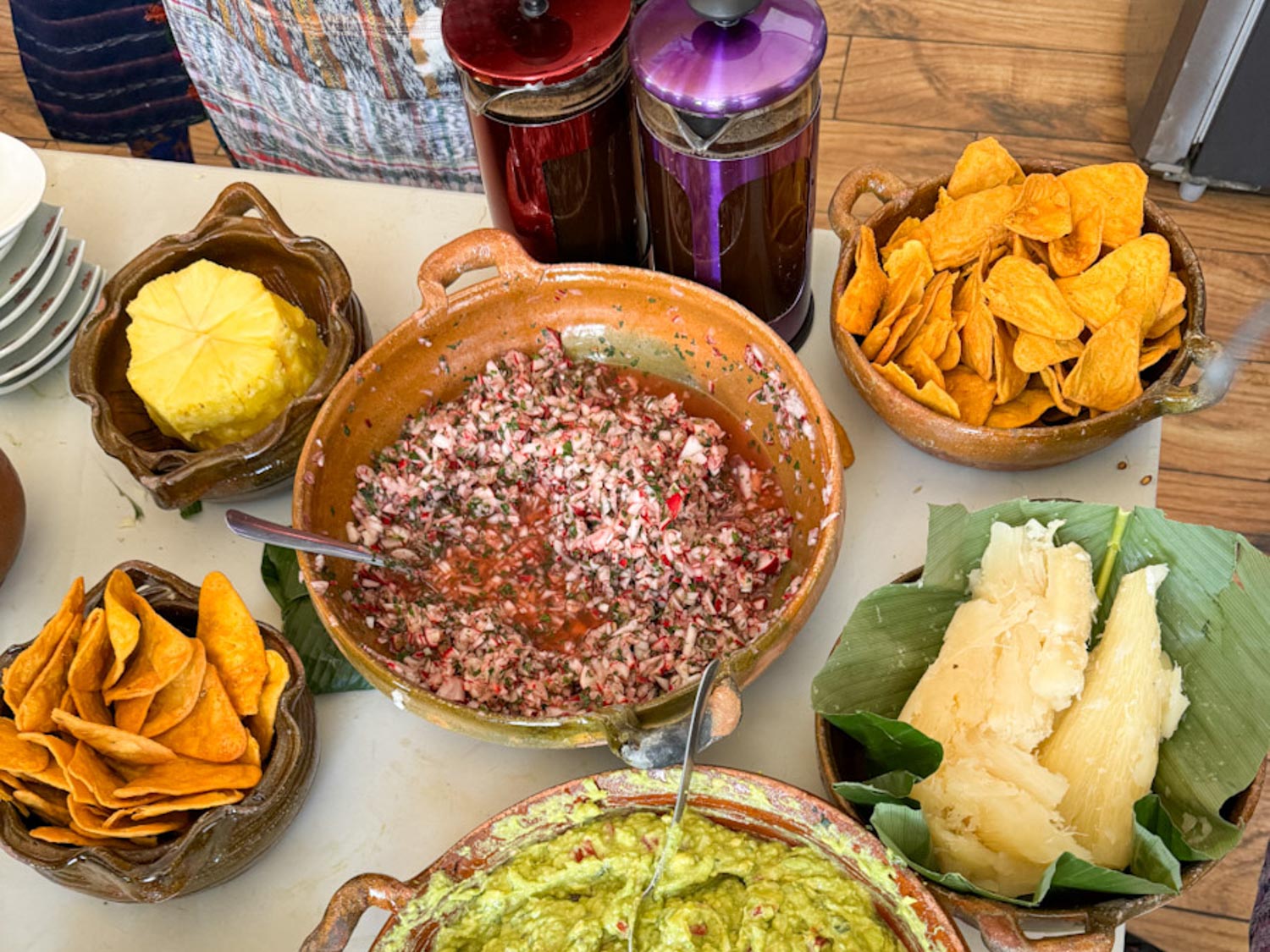 A bowl of picado de rabano surrounded by bowls of other food