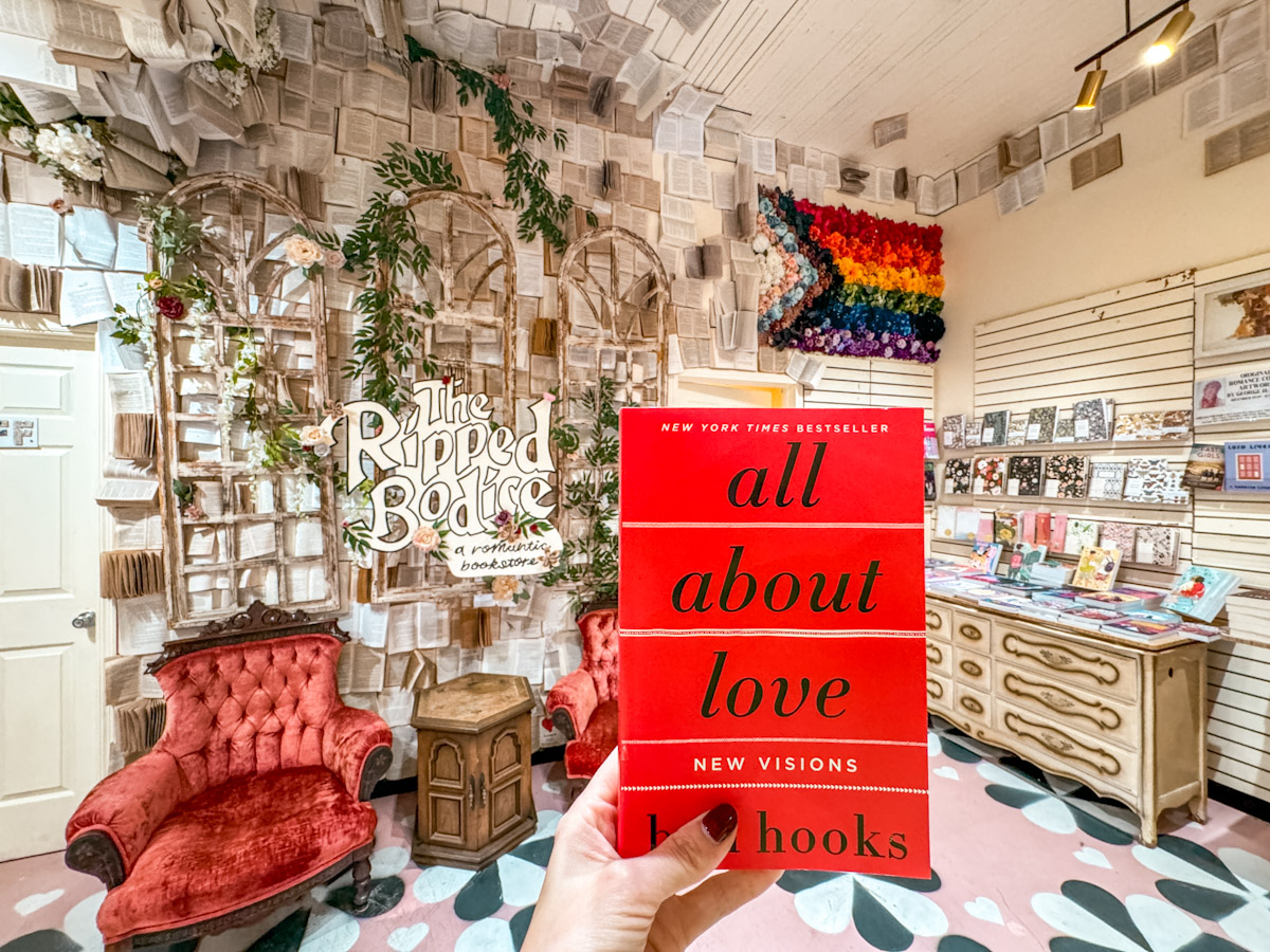 A book with title "All About Love" taken inside The Ripped Bodice bookstore in New York City.
