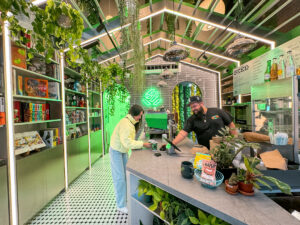A woman talking to a man behind a counter in a cafe indoor things to do in NYC