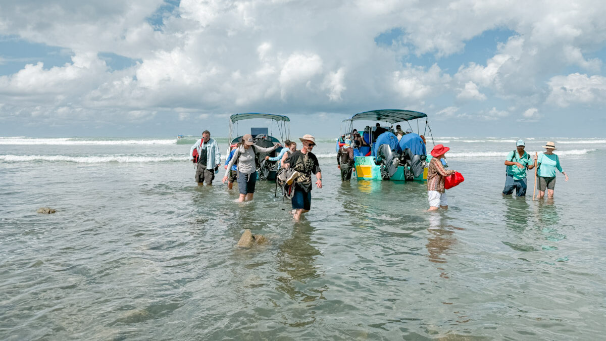 People leaving boats in a sea in Costa Rica.