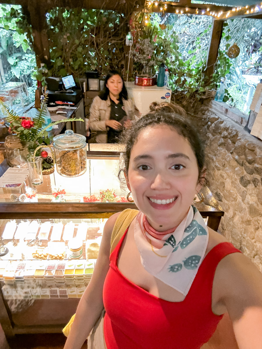 A woman taking a picture of herself at a macadamia shop.