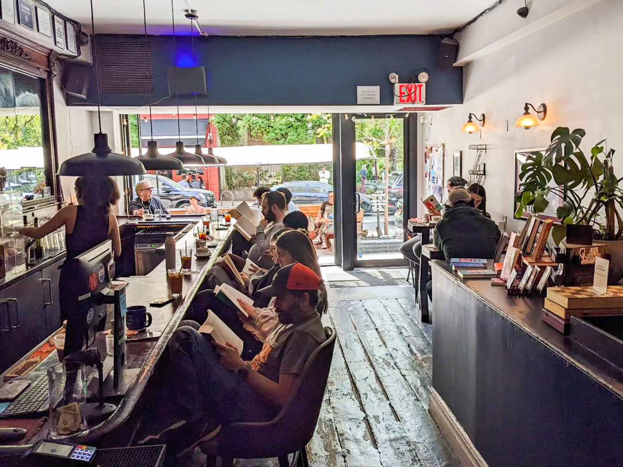 People reading at a bar in one of the bookstores in NYC.