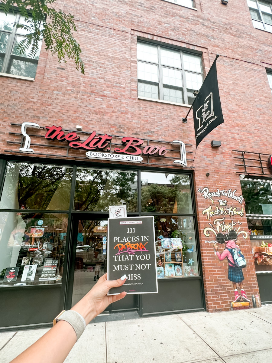 A book with The Lit Bar bookstore in the background.