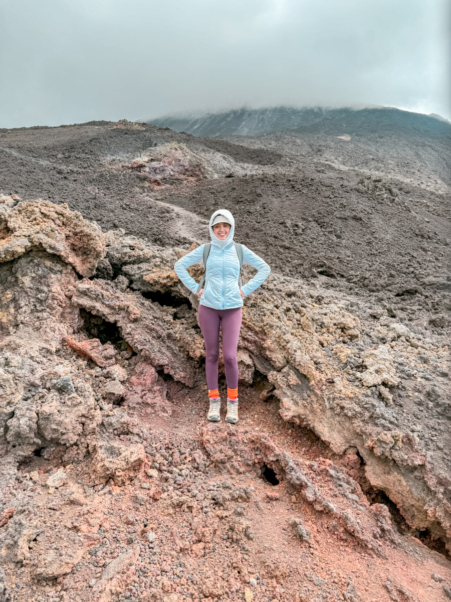 A woman standing on Volcan de Pacaya in Antigua, Guatemala.