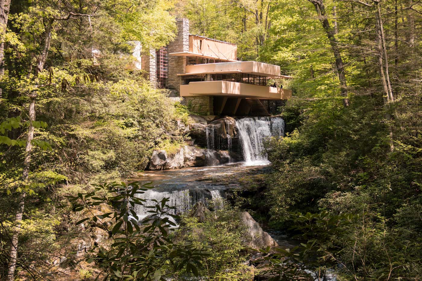 A building standing above a waterfall and surrounded by the forest in Laurel Highlands, Pennsylvania.