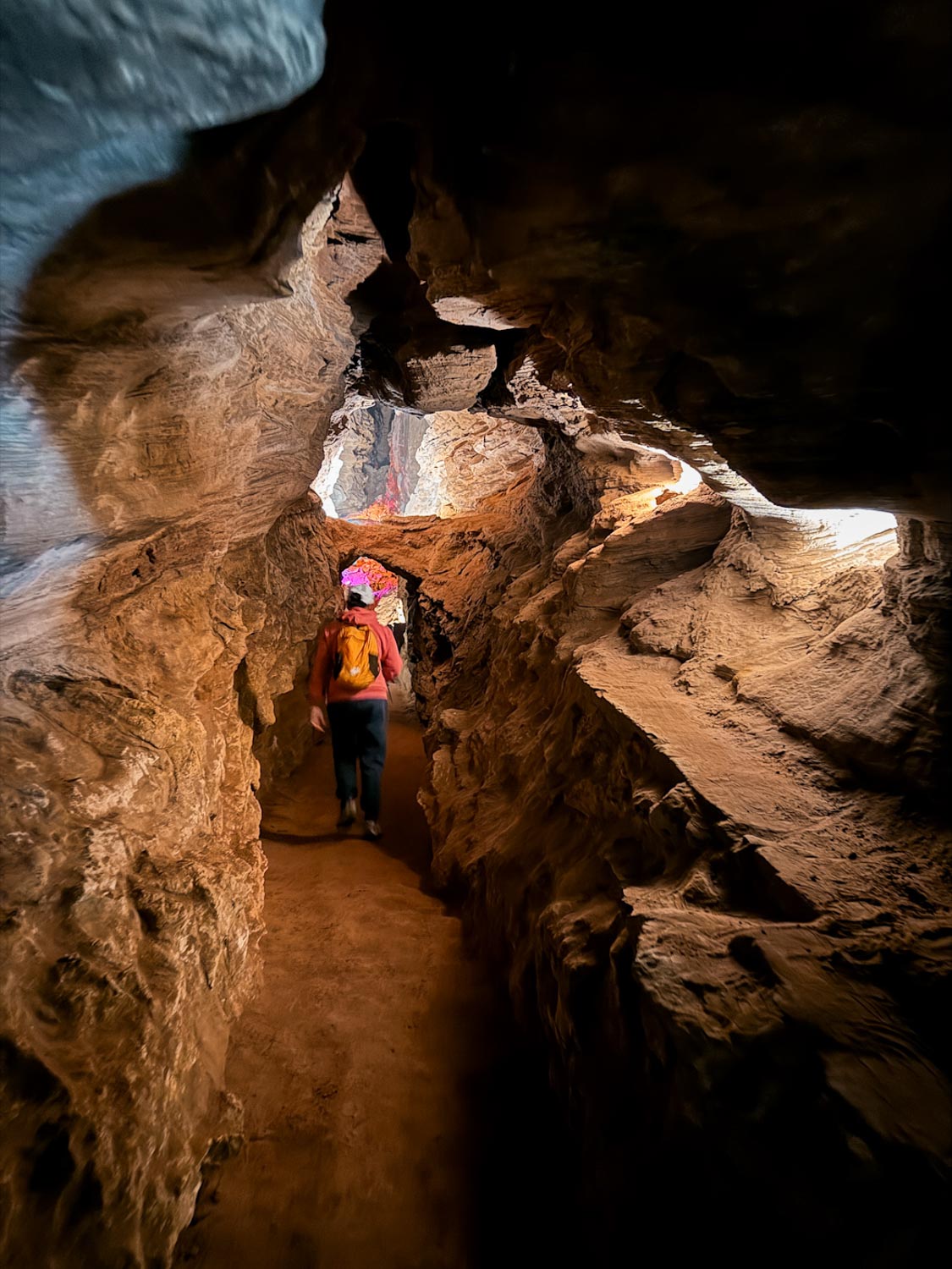 A person walking inside sandstone passages in Laurel Caverns in Laurel Highlands, Pennsylvania.