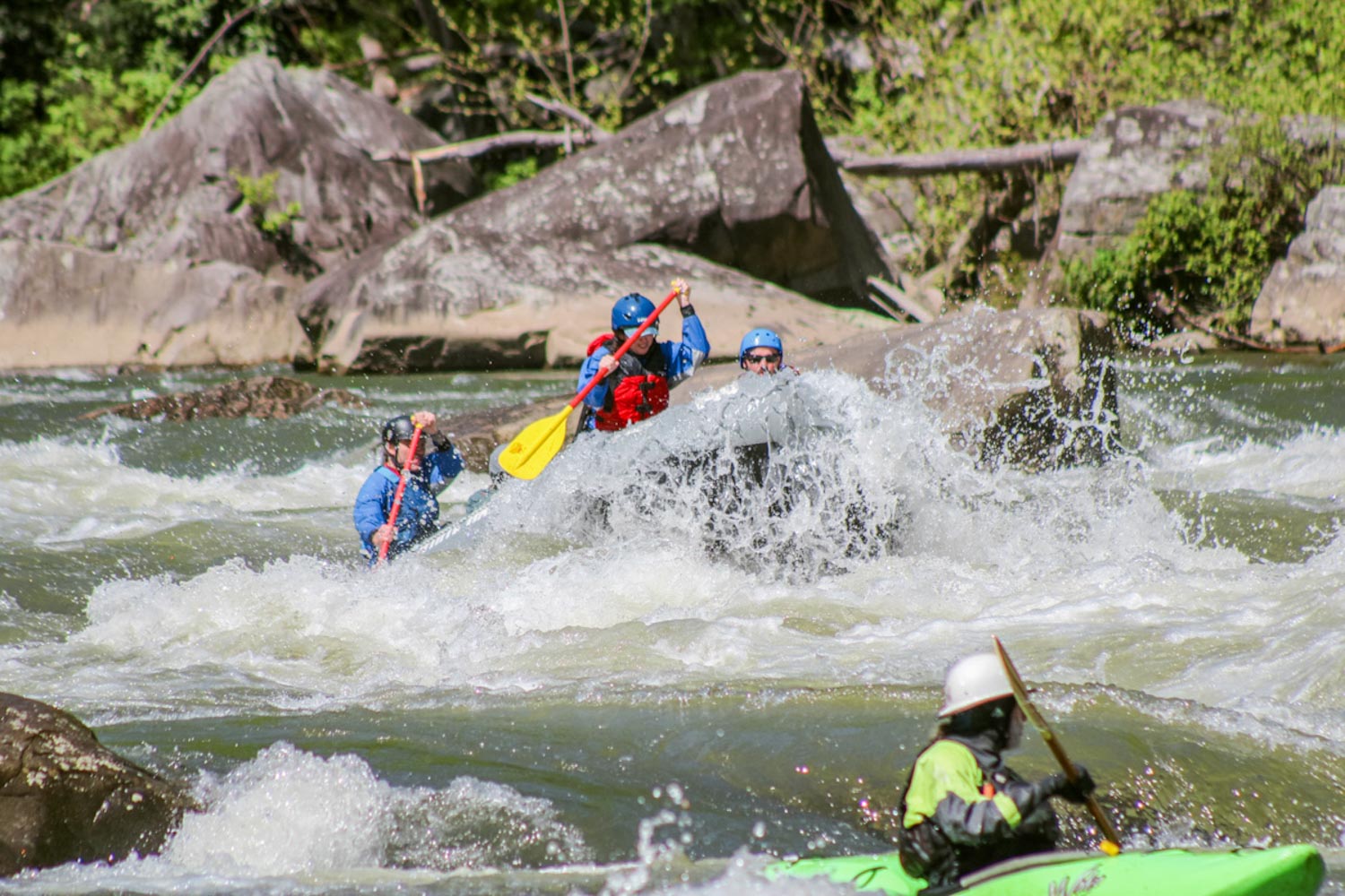 A group of people whitewater rafting along the rapids of a river in Laurel Highlands, Pennsylvania.