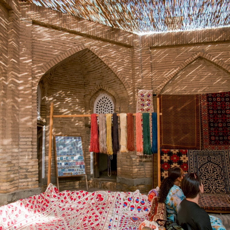 A shop in Uzbekistan with rugs and embroidered tapestries.