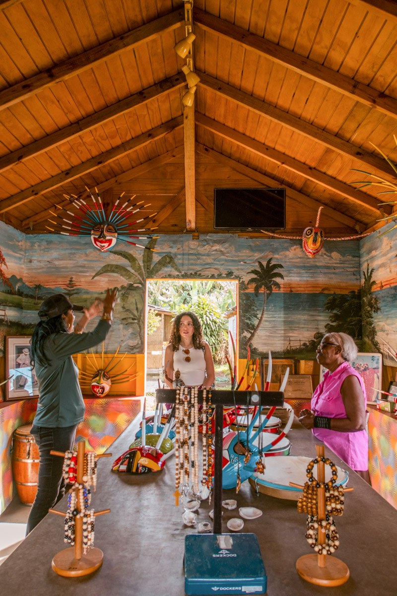 Three women talking and standing inside an art gallery in Puerto Rico.