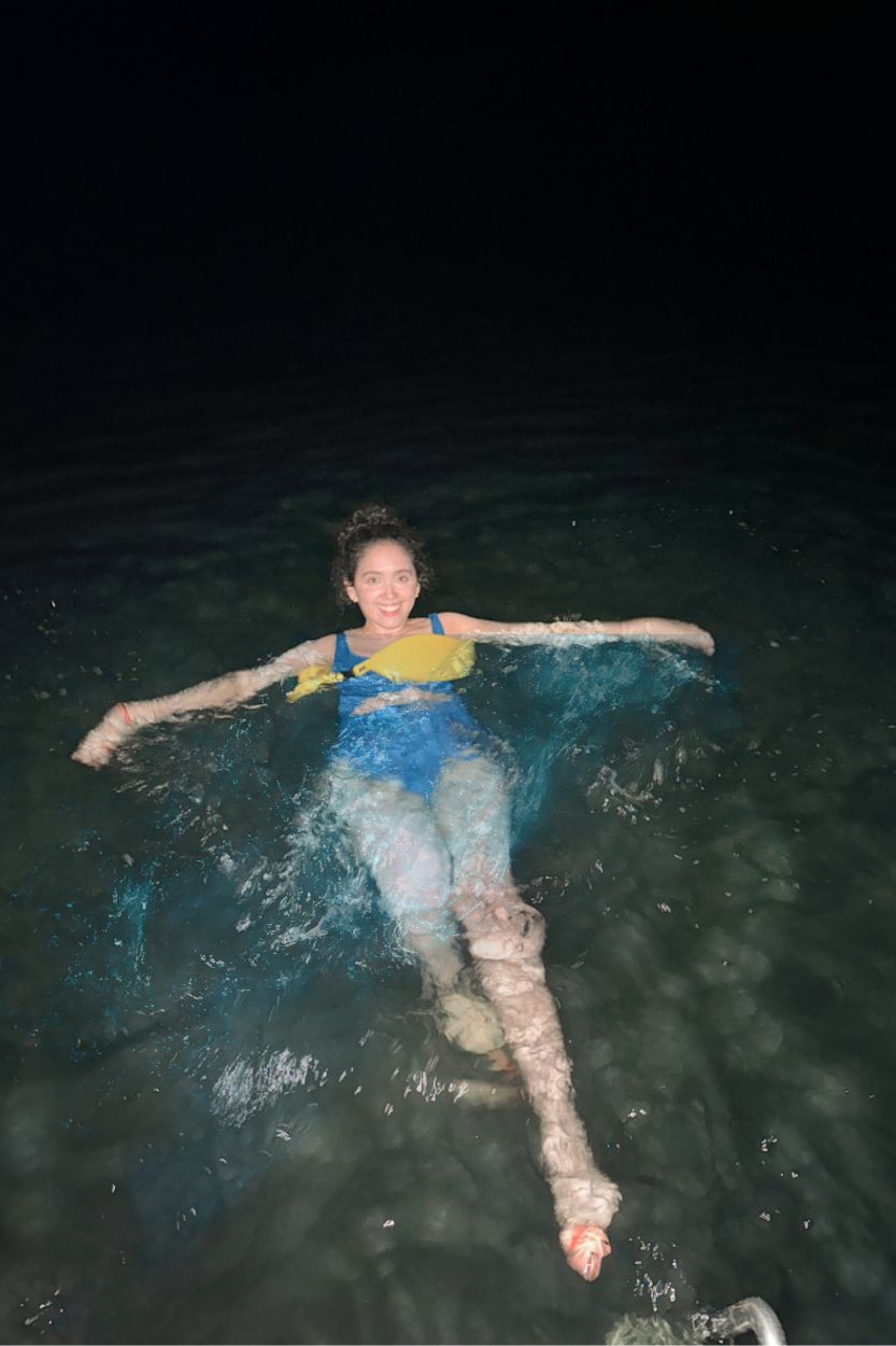A woman swimming in the sea in Puerto Rico at night.