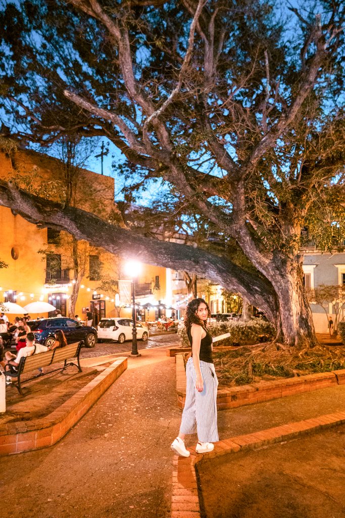 A woman walking on a small park in the middle of a road in San Juan, Puerto Rico.