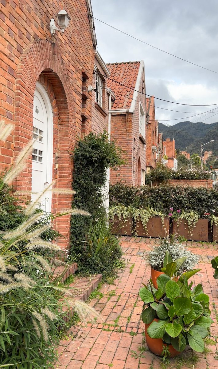 The facade of a boutique shop with brick walls and plants in Bogota.