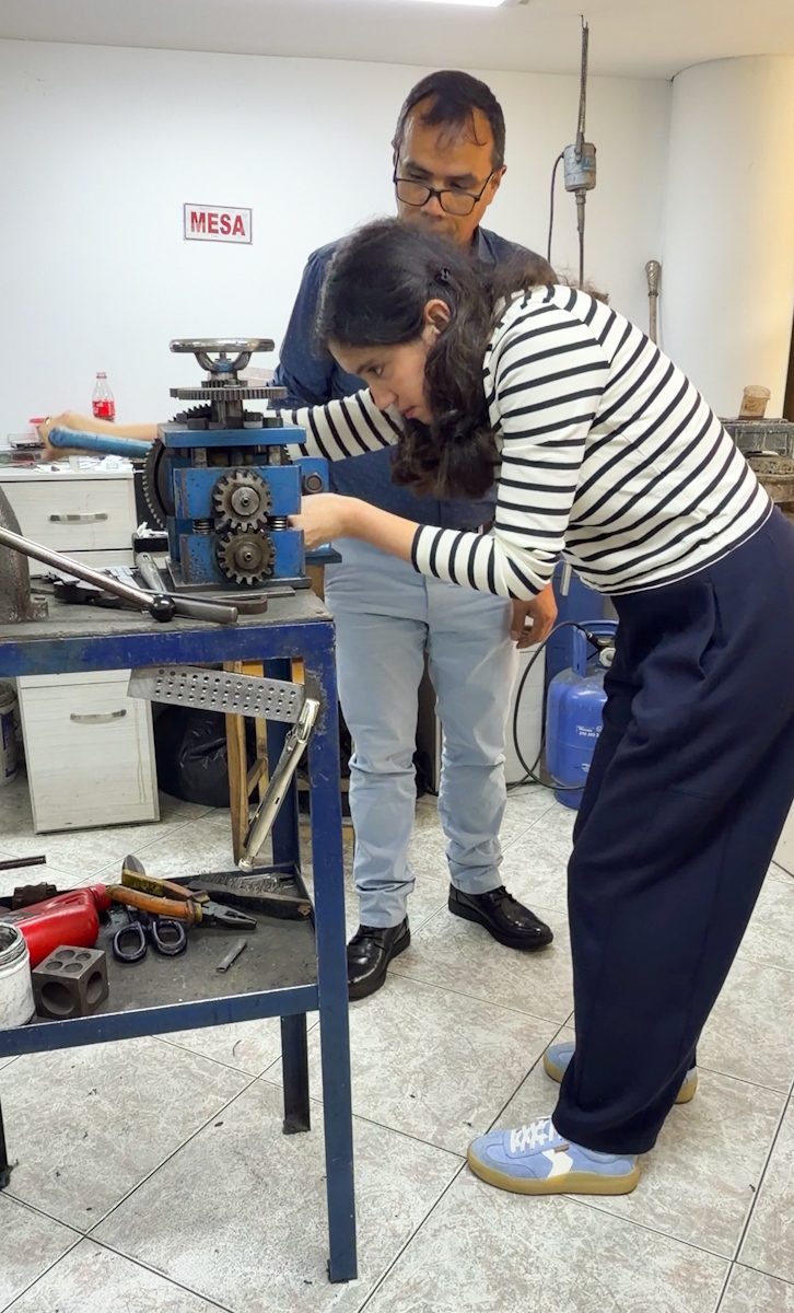 A woman and a male teacher at an emerald jewelry making workshop in Bogota.