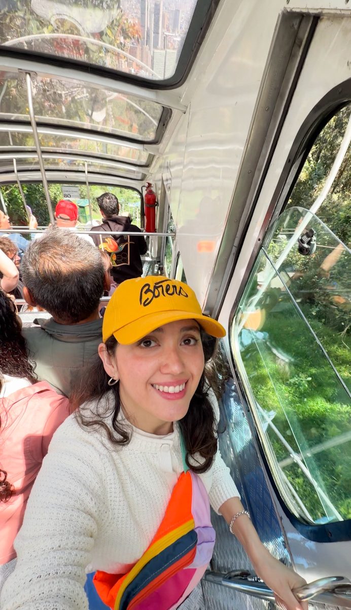 A woman riding a funicular with other people in Bogota.