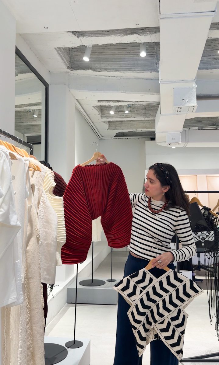 A woman browsing through racks of clothes in a boutique in Bogota.