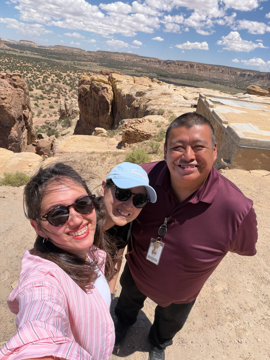 Two women and a man standing in a desert in Albuquerque, New Mexico.