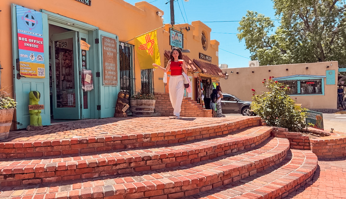 A woman walking on the front steps of a cafe in Old Town Albuquerque, New Mexico.