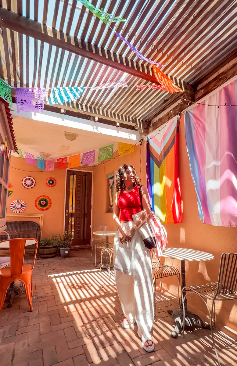 A woman inside a cafe in Albuquerque, New Mexico with colorful decor.